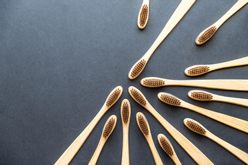 bamboo toothbrushes on dark rough background. plastic-free concept