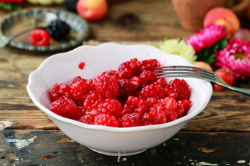 Preparing raspberry preserves. Bowl with ripe fruits.