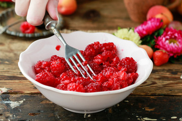 Preparing raspberry preserves. Bowl with ripe fruits.