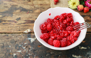 Preparing raspberry preserves. Bowl with ripe fruits.
