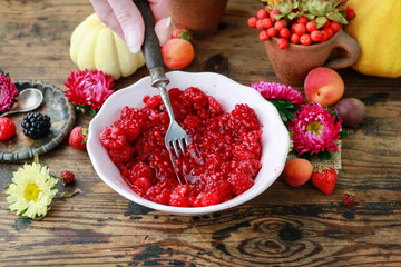 Preparing raspberry preserves. Bowl with ripe fruits.