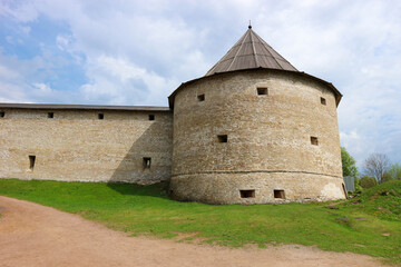 Fototapeta na wymiar Round tower of medieval russian fortification lanmark old ladoga fortress