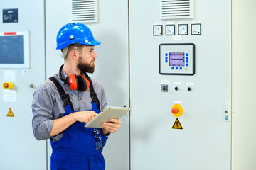 worker with helmet ,ear protector and tablet computer