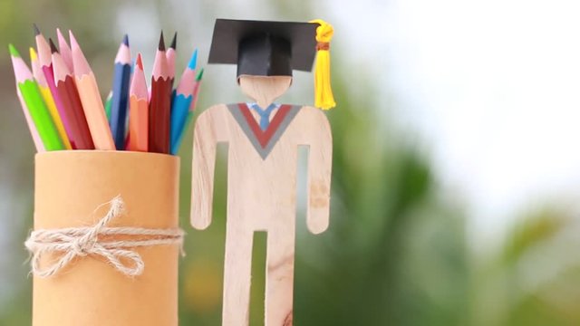 Models graduation celebration with color pencils box background, Back to School. education learning concept, university achievement for study abroad international, alternative studying idea.