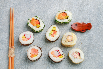Sushi set on grey stone background.