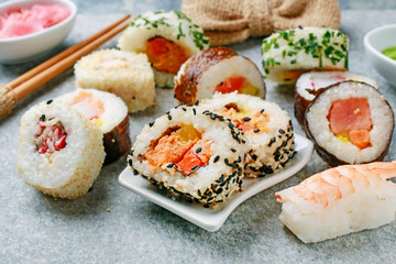 Sushi set on grey stone background.