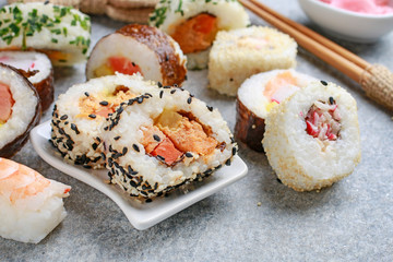 Sushi set on grey stone background.