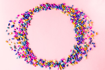 Multicolored seashells background on pink, top view, copy space. Summer concept
