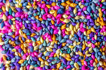 Multicolored seashells background on pink, top view, copy space. Summer concept