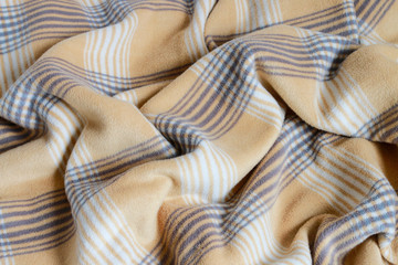 Beige blanket on the new mattress.