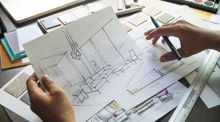 Architect designer Interior creative working hand drawing sketch plan blue print selection material...