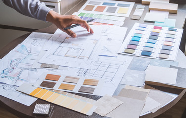 Architect designer Interior creative working hand drawing sketch plan blue print selection material...