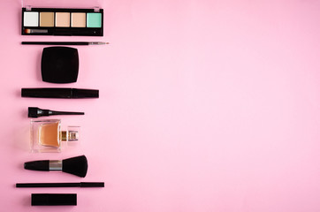 Different makeup products composition on pink background