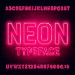 Neon alphabet font. Red light bulb letters and numbers. Brick wall background. Stock vector typeface for your typography design.