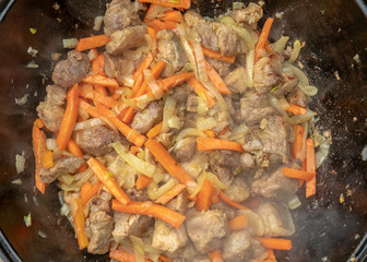 step-by-step process of cooking pilaf in a cast iron cauldron