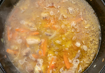 step-by-step process of cooking pilaf in a cast iron cauldron