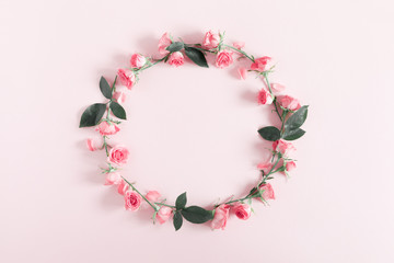 Flowers composition romantic. Wreath made of flowers pink roses on pastel pink background. Happy woman's day. Valentine's Day. Flat lay, top view, copy space