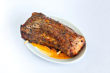 Cooked brisket sprinkled with spices and herbs.