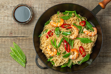 Asian dish of fried rice noodles with shrimp and vegetables
