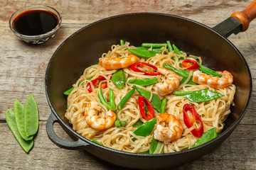 Asian dish of fried rice noodles with shrimp and vegetables