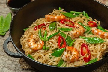 Asian dish of fried rice noodles with shrimp and vegetables
