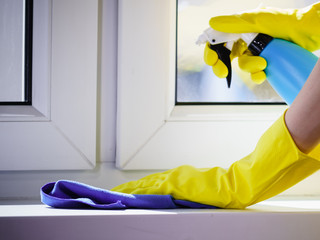 Woman cleaning windowsill