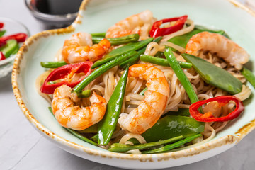 Asian dish of fried rice noodles with shrimp and vegetables