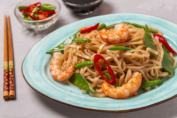 Asian dish of fried rice noodles with shrimp and vegetables