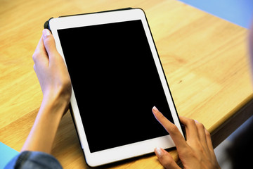 Woman hand using digital tablet with blank screen on background for mock up, template, people technology and lifestyle