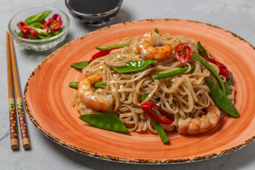 Asian dish of fried rice noodles with shrimp and vegetables