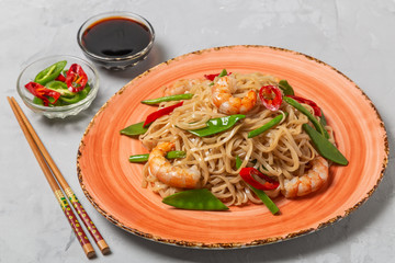 Asian dish of fried rice noodles with shrimp and vegetables