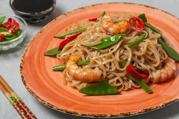 Asian dish of fried rice noodles with shrimp and vegetables