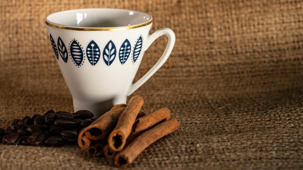 coffee beans and cinnamon are on the table