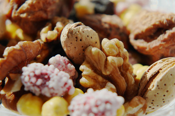 Sweet dried fruits and nuts in a crystal vase.