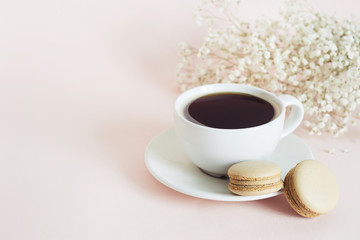 Cup of coffee with french coffee macarons cookies. Holiday morning concept