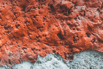 Texture of old red wall. Background of Wall fragment with broken stucco and bricks