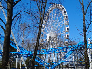 Ferris wheel on a background of blue sky