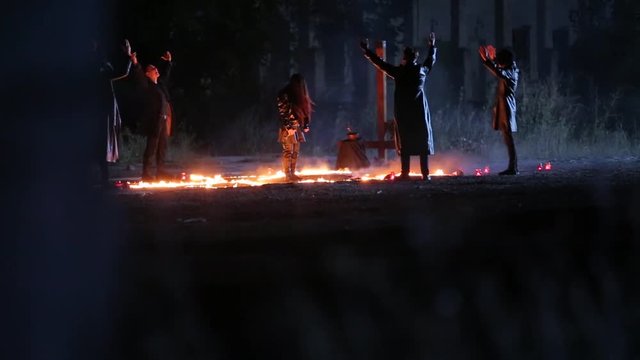 Dark ritual at night. Satanic prayer performing for Devil