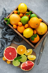 box with citrus fresh fruits on a concrete background