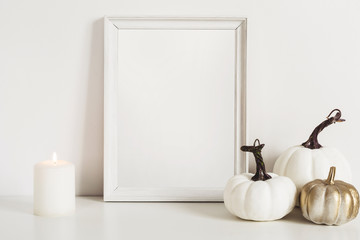 Photo frame and white pumpkins. Mockup Copy space for artwork. Autumn decor in interior