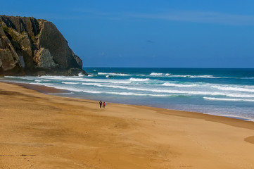 Surfers on theUrsa beach, Portugal - westernmost point of mainland Europe