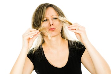 Blond woman showing grimace of problem with long straight hairs.