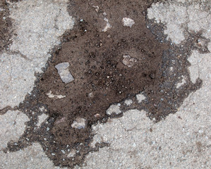 Cracks and pit on the asphalt road as background