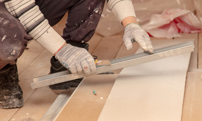 Worker cuts with a knife drywall repair