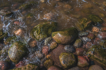 Stones of varying size are on the seashore