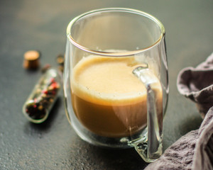 coffee with milk (cappuccino or latte) flavored drink in a transparent cup. food background. top