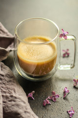 coffee with milk (cappuccino or latte) flavored drink in a transparent cup. food background. top