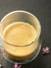 coffee with milk (cappuccino or latte) flavored drink in a transparent cup. food background. top