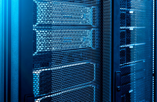 Close up server racks in modern data center neon blue tone background