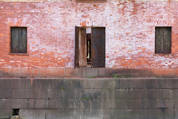 old rusty window and door on old brick wall